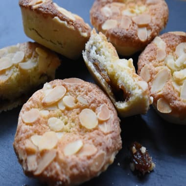 Gluten Free Mince Pies with a Frangipane Topping with one pie cut in half showing the mincemeat filling.